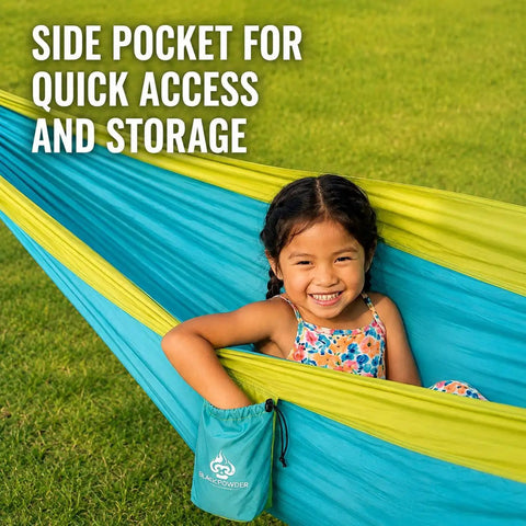 Child enjoying Ultra Lightweight Camping Hammock With 500 Lb Capacity and tree straps, featuring side pocket for storage.