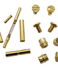 Straight Up Quality Polished Gold Plated 1911 Grip Screws Pins And Bushings Set showing various components and fasteners.