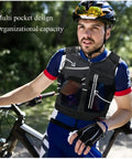 Cyclist wearing Trail Running Hydration Pack with multi-pocket design and phone holder reflective trek vest for teens L size