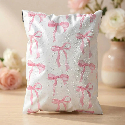 Pink Bow Poly Mailers 10x13 Inch 200 Count Heavy Duty Waterproof Self Adhesive Shipping Bags For Boutique Shops Small Biz And Gift Packaging Options Today, showcasing water resistance with floral background.