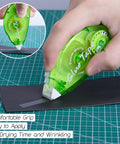 Person using 12 Pack Double Sided Tape Roller For Scrapbooking And Crafts, Permanent Adhesive Dispenser on black paper