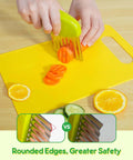 Kids kitchen knife set with green-handled crinkle cutter slicing carrots on a yellow cutting board