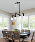 Dining room with Dope Five Light Black Modern Chandeliers With Clear Glass Shades Industrial Pendant Lights over table.