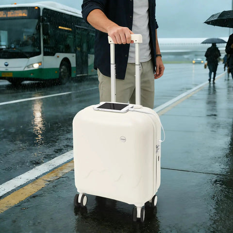 Mint Blue And Pearl White 18 Inch Carry On Suitcase With A Built In USB Charging Port and smartphone on top in the rain.