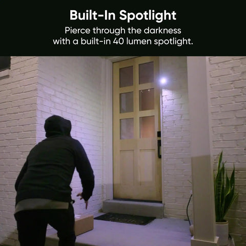 Person approaching a well-lit front door with 1080p Indoor Outdoor Security Camera With Color Night Vision Built In Spotlight Motion Detection Two Way Audio Wi Fi Alexa And Google Compatible Free Expert Setup White.