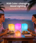 Couple dining by the beach with 7 Inch LED Mood Cube Light Vibe With 16 RGBW Color Options Cordless Rechargeable Night Light.