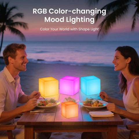 Couple dining by the beach with 7 Inch LED Mood Cube Light Vibe With 16 RGBW Color Options Cordless Rechargeable Night Light.