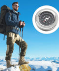 Hiker with Mini Stainless Steel Compass for Camping and Hiking on mountain