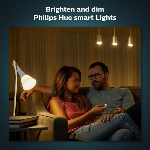 Couple using Smart Wireless Dimmer Switch V2 For Hue Lights No Bridge Needed Setup Is A Breeze in living room