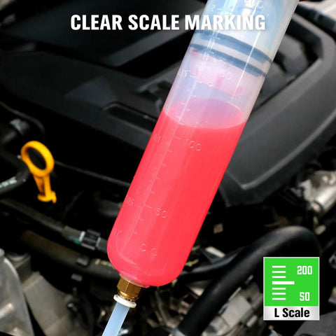 Close-up of a 200cc plastic fluid extractor syringe with pink liquid and blue tubing in a car engine bay.