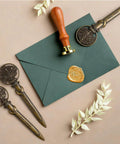 Antique Metal Letter Opener Set Pack Of 3 with Gift Box tree-shaped envelope slitter in bronze finish beside green envelope