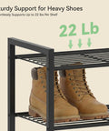 Heavy Duty Ten Tier Metal Shoe Rack Holds Up To Twenty Two Pairs Tall Slim Entryway Organizer With Adjustable Bottom Shelf And Secure Anti Tip Strap For All Your Kicks Black, showing sturdy shelf with two heavy boots.