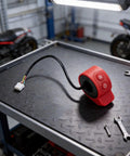 Electric Scooter Thumb Throttle Switch For 5 Wire Controllers in red with ABS body, shown on a workbench, fits HX6 Pro and other models.