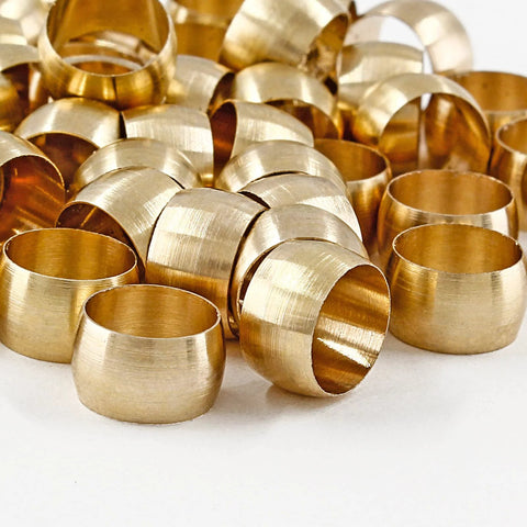 Close-up of brass compression sleeves for 1/4 in tube OD, assorted 50-piece set