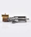 Miniature metal linear actuator with screw slide and attached brown circuit board with 4 pads (side view)