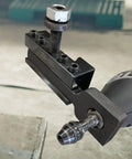 Close-up of a Lathe Tool Post Grinder Attachment 3/4-12 Thread, steel with black zinc finish, attached to a rotary tool.