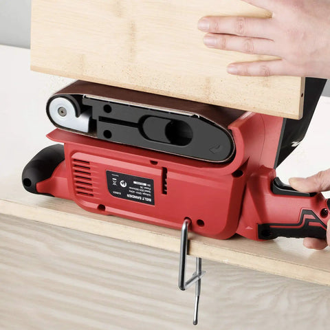 Beast 7 Amp Belt Sander With Six Variable Speed Settings clamped to a table during use for woodworking project