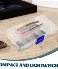 Compact eyeglass repair kit with screws, screwdriver, tweezers, nose pads, ear hooks, and cleaning cloth on wooden table.
