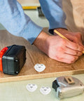 Kickstart Your Home Setup With Heavy Duty Peel And Stick Caster Wheels Featuring Stainless Steel Rollers For Furniture And Appliances Smooth Glide Movement Easy Install Durable Glides That Move Your Gear Hassle Free on a person measuring wood.