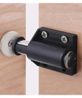 Grab These 8 Pack Single Magnet Cabinet Catches For The Perfect Door Stopper And Rebounder With Invisible Design And Seamless Clean Look For Cupboards And Wardrobes - Close-up of a black cabinet catch mounted on wood.
