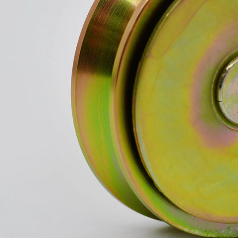 Close-up of Badass Heavy Duty Galvanized 4 Inch V Groove Wheel with precision bearing, showcasing its gold finish and smooth surface.