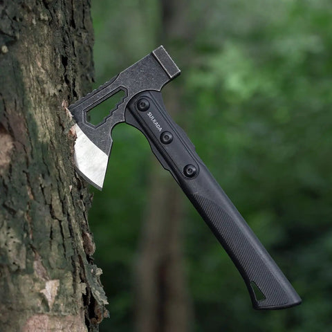 Camping Hatchet For Real Wood Chopping And Outdoor Survival embedded in a tree, showing stainless steel blade and black handle
