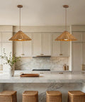 DLITISH 19'' Hand Woven Rattan Pendant Light with Glass Shade above a kitchen island with rattan bar stools.