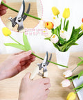 Person using Eight Piece Garden Shears Set In Four Color Variants For All In One Yard Work With Bypass Blade Pruners to cut flower stem.