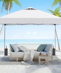 One Person Setup Ready 10x10 Pop Up Canopy Tent With Sandbags, Easy Up Gazebo on a beach, white roof, waterproof sunproof fabric