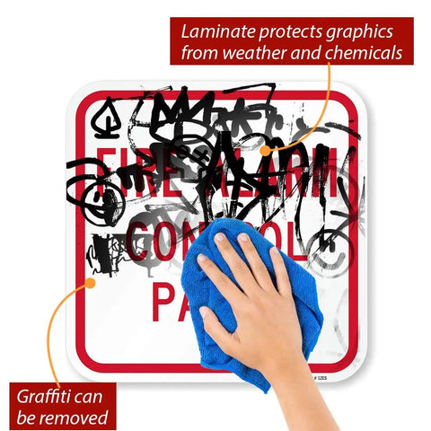 Hand wiping graffiti off K-5834-AL-12x12 Fire Alarm Control Panel Sign Red On White Aluminum Outdoor Ready Laminated Weatherproof Graffiti Resistant