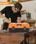 Man using tools near 16.5 Inch Three Layer Folding Tool Box Organizer With Portable Handle for home repairs in workshop setting.