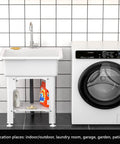 Freestanding Plastic Laundry Sink With Detachable Washboard For Indoor And Outdoor Use 25.4 Inch Wide By 22 Inch Deep By 31.5 Inch Tall Utility Sink With Cold And Hot Water Faucet Hoses And Drain Kit For Laundry Room Garage Basement Garden next to a washing machine in a tiled room.