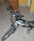 Mountain bike with a black Bike Riser Handlebar for Mountain Biking, 31.8mm Clamp, 620mm Length, Aluminum Alloy 6061, in an indoor setting.