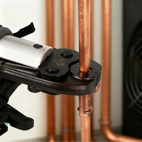 Close-up of Seven Piece Press Jaws Set for Refrigeration and Plumbing from Quarter Inch to One and One Eighth Inch in use on copper pipe.