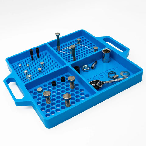 Silicone Fastener Tray For Bolts, Nuts, And Bits With Handy Handle, blue, holds various fasteners, visible on workbench.