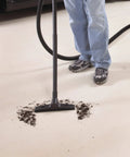 Person using 1.5 Inch Diameter Wet Dry Vacuum Accessory Kit With 2 Extension Wands, Elbow Grip, And 12 Inch Floor Nozzle for cleanup