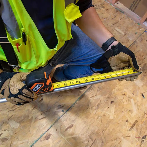 Heavy Duty Tape Measure With 30 Foot Double Hook, Double Sided Nylon Reinforced Blade, 13 Foot Standout in use by worker