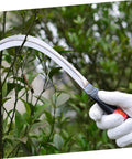 Gardener using 2-Pack Mowing Sickle Weeding Hook with No Slip Grip for Gardening and Harvesting among green foliage
