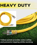 50 Ft Lighted Outdoor Extension Cord With 10/3 SJTW Heavy Duty Yellow Cable, coiled on grass with LED indicator end visible