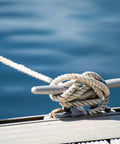 75ft Double Braid Nylon Boat Dock Line with Stainless Steel Thimble for Mooring and Towing, secured on boat cleat, on water