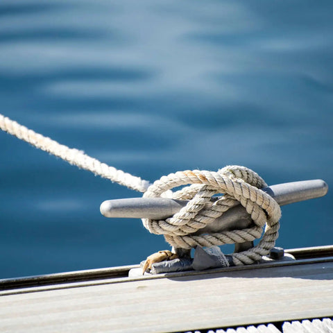 75ft Double Braid Nylon Boat Dock Line with Stainless Steel Thimble for Mooring and Towing, secured on boat cleat, on water