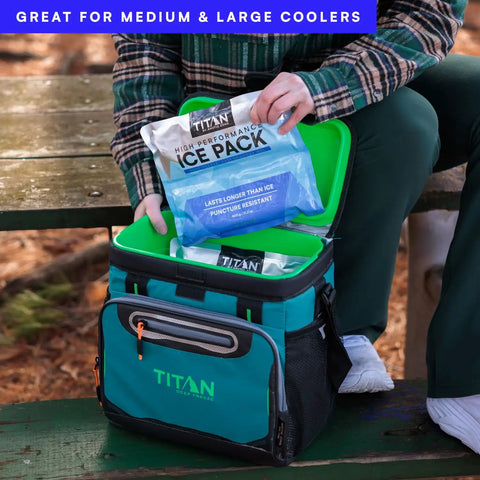 Person placing Deep Freeze Titan Ice Pack 2 Pack 600 Gram High Performance Puncture Resistant Cold Pack in green cooler