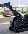 Versatile Mini Crawler Skid Steer Loader With Hydraulic Cylinder raised in parking area