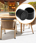 Tough As Nails Black PVC Rubber Furniture Leg Sleeves, Pack Of 16, displayed on outdoor chairs for floor protection.