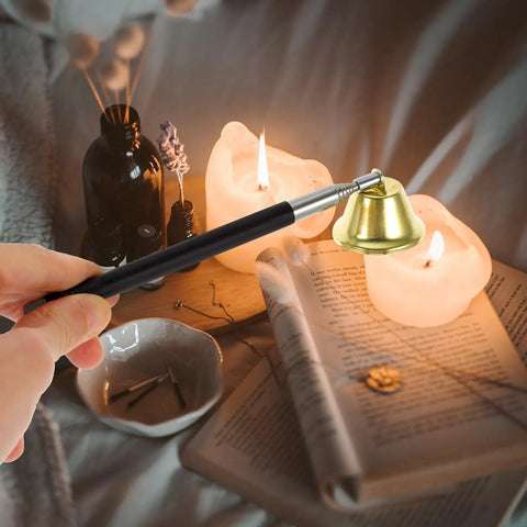 The Real Deal Copper Telescopic Bell Candle Fire Extinguisher With Hella Compact Retractable Design For Quick Flame Control and Solid Home Safety Shield Plus A Tight Little Knockout Gift For Any Kitchen Or Altar Setup, holding bell by lit candles.