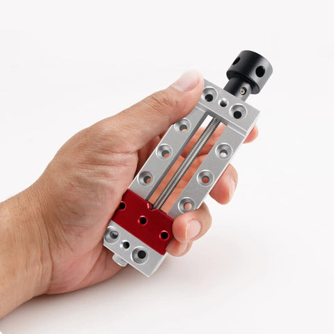 Nifty Mini Bench Vise Featuring Slick Bottom Slider And Precision Flat Jaws For Drill Press Work No Sweat Clamp Lock Solid 50mm Clamping Range, hand holding mini grip tool.