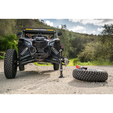 Electric High Lift Off Road Jack With 2000 LB Lift Capacity lifting ATV, showing 14 Inch Lift and 17 Inch Height Adjustment on trail