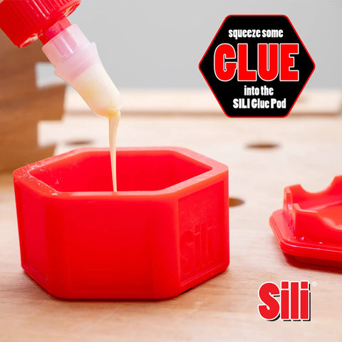 Glue Pod being filled, close-up view showing red hexagonal container from Glue Pod With Three Micro Glue Brushes And Sealable Lid Set.