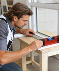 Magnetic Pocket Level Mini Bubble Spirit Level Tool With 2 Vials 90°/180° being used by a man for accurate leveling on a window frame.