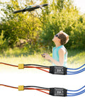 Two Pack 30A Brushless ESC Speed Controllers With XT60 Connectors And 3.5mm Bullet Plugs For RC Drones Planes And Helis displayed on grass